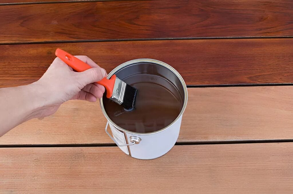 Applying protective deck paint with help from a trusted painting company in Portage, MI