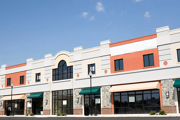Modern commercial retail building with fresh white and coral exterior by an exterior painter in Kalamazoo, MI